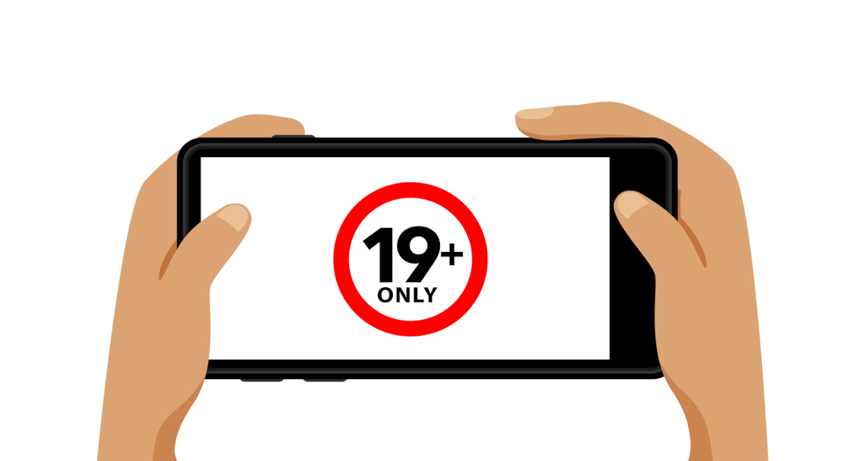 19+ on smartphone blank screen in hand isolated on white, adults age only concept, over 19 plus only censored on mobile phone white screen, adult content Ontario Extends Comment Period for Tougher iGaming Ad Standards