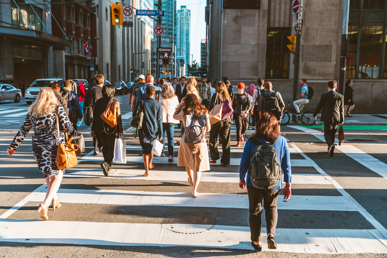 crowd of people crossing Adelaide st in Toronto, Ontario. Spin Genie's Survey Shows New Players Form A Large Chunk of Ontario's Online Gamblers.